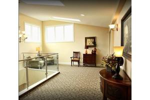 A well-lit hallway with elegant furniture and decor.