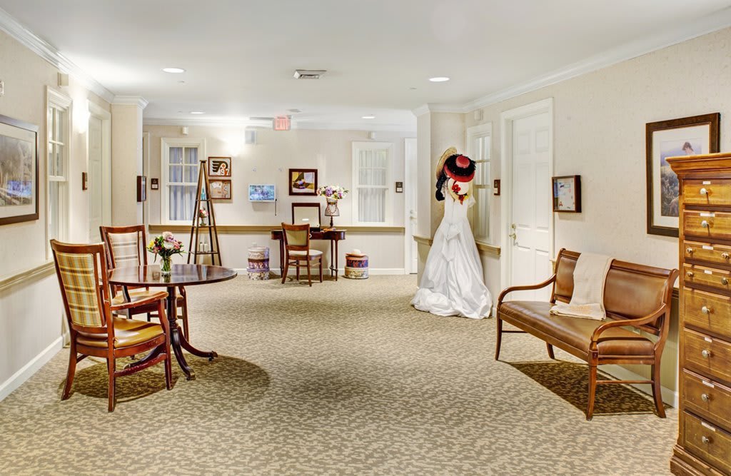 A hallway with elegant decor and a person in a wedding dress.