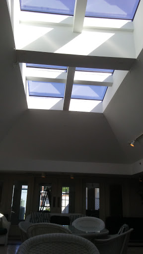 A view of a modern ceiling featuring skylights that allow natural light to illuminate the interior space.