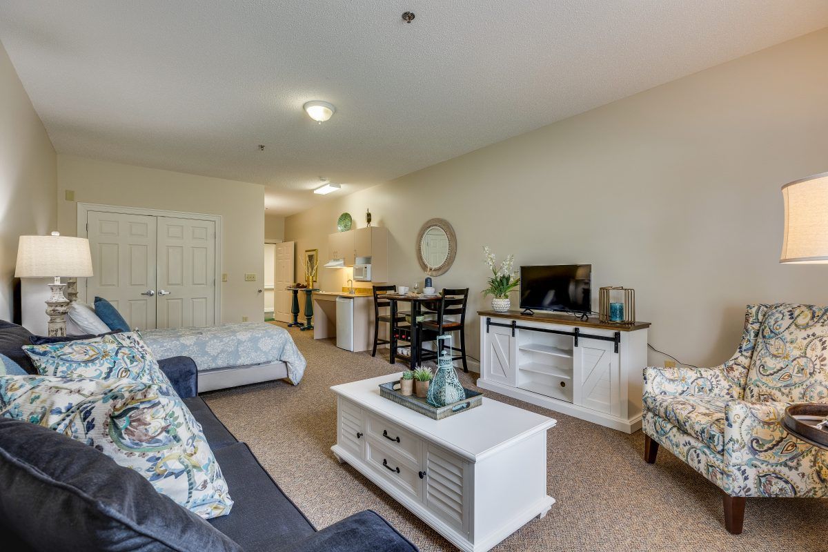 A cozy living room with a sofa, coffee table, and entertainment center in a spacious open layout.