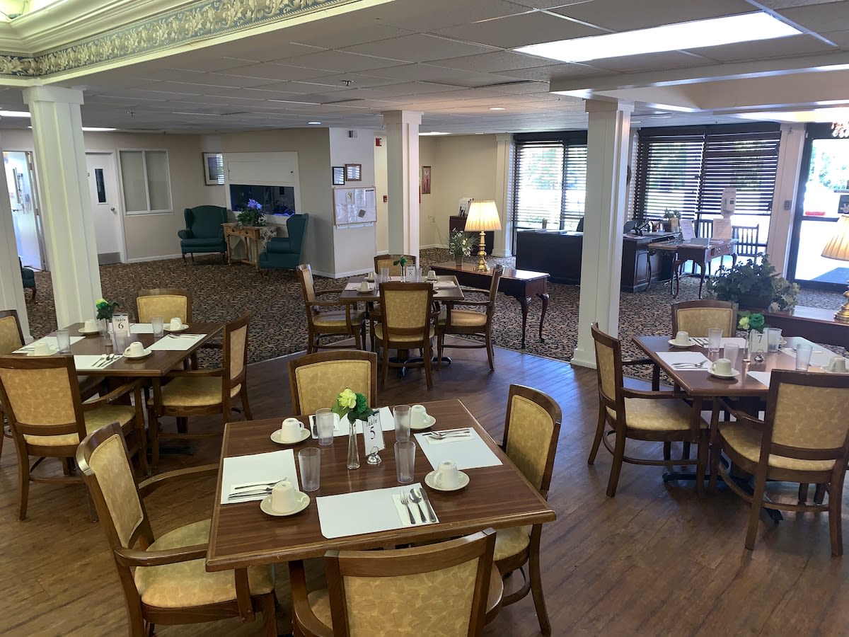 A cozy dining area with neatly arranged tables and chairs.