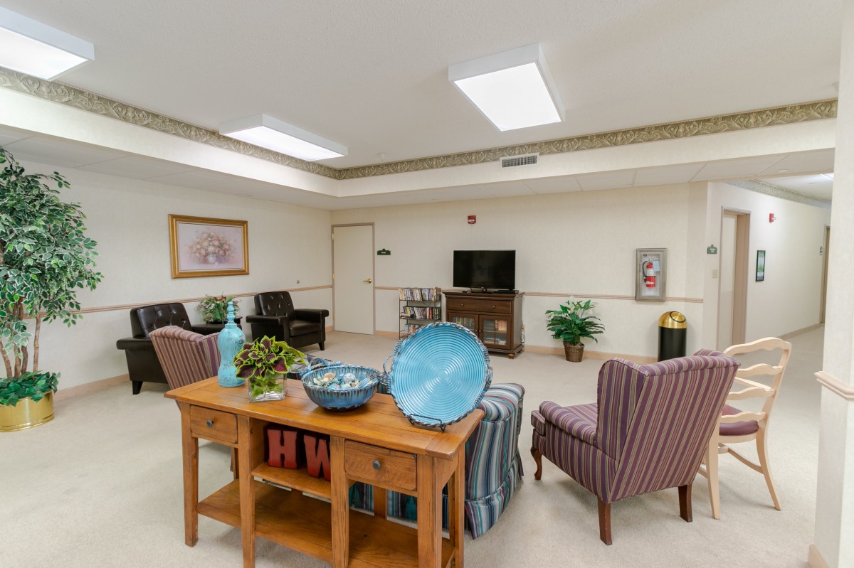 A well-decorated living room with comfortable seating and a TV.