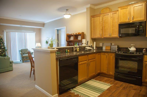 A cozy modern kitchen featuring wooden cabinets and an open layout.
