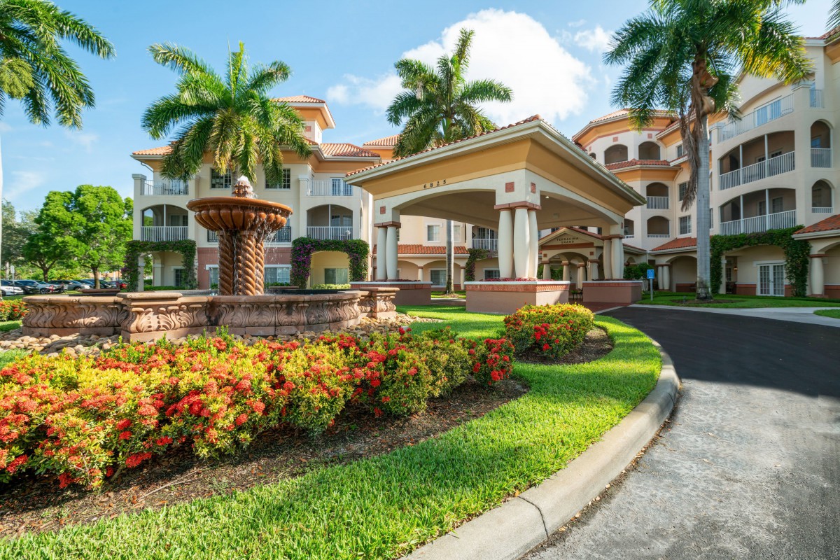A luxurious tropical resort with beautiful landscaping and palm trees.