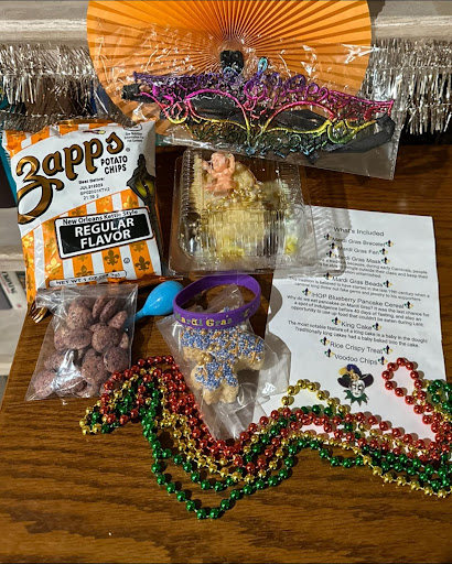 A festive collection of Mardi Gras goodies, including colorful beads, snacks, and lively decorations.
