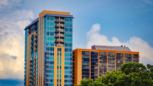 A view of contemporary high-rise buildings showcasing colorful glass facades against a blue sky.
