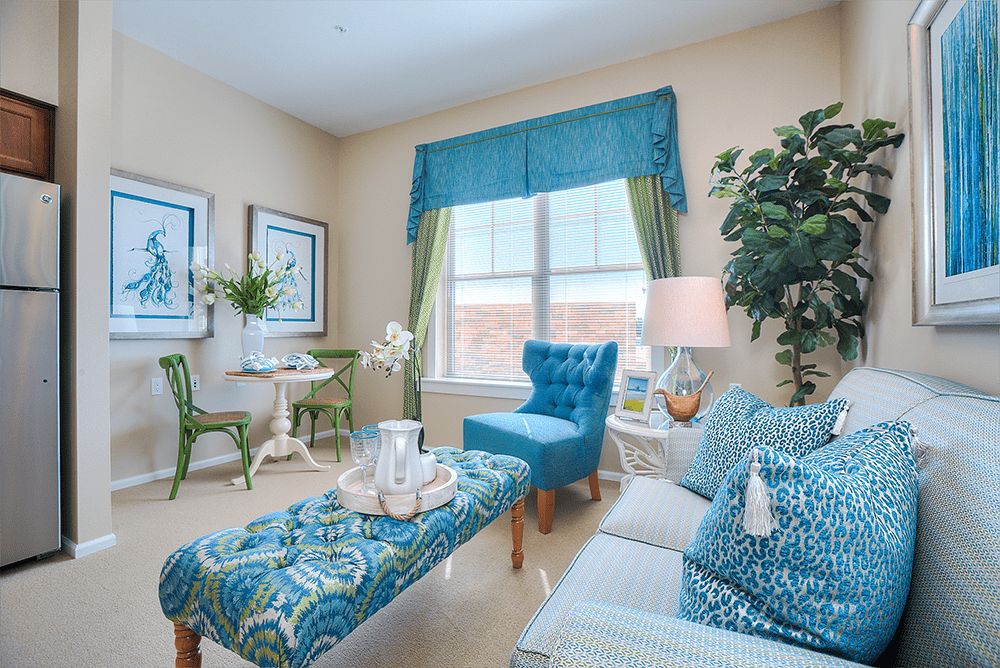 A bright and cozy living room with blue decor and comfortable seating.