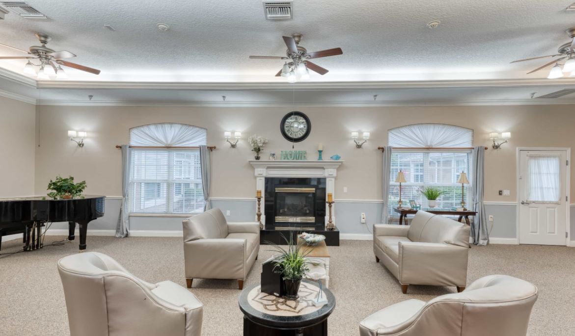 A cozy living room with comfortable seating, a fireplace, and elegant decor.