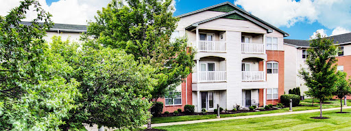 A charming residential apartment building surrounded by lush greenery.