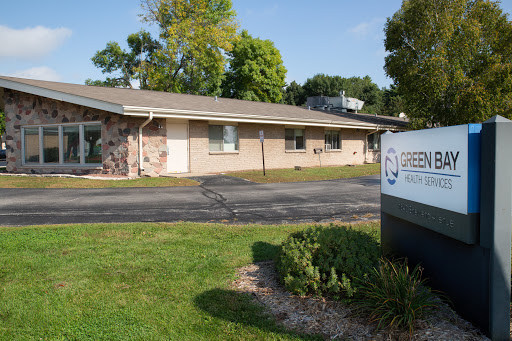 A well-maintained office building surrounded by green landscaping.