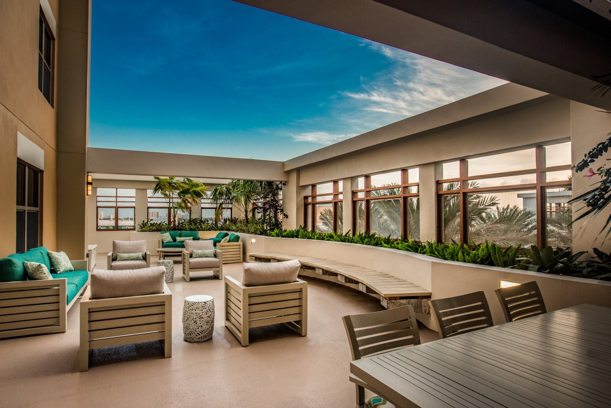 A modern rooftop lounge with comfortable seating and scenic views.
