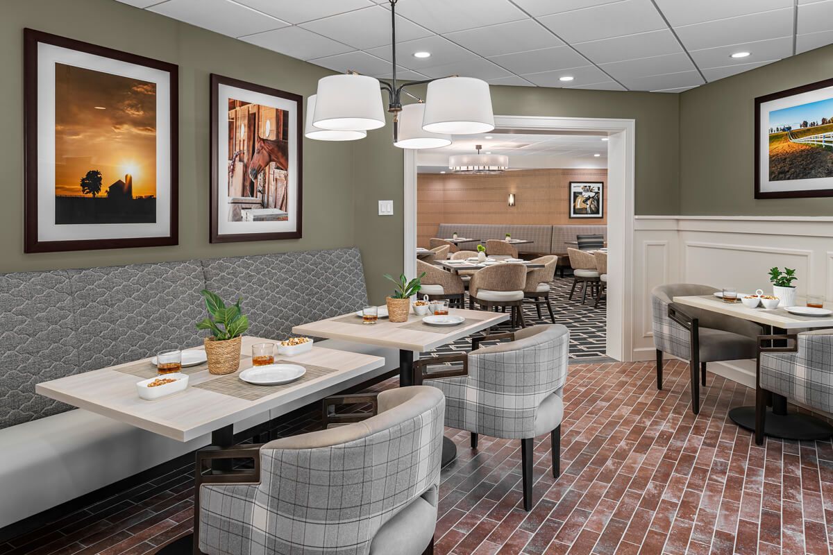 A modern restaurant interior with neatly arranged tables and comfortable seating.
