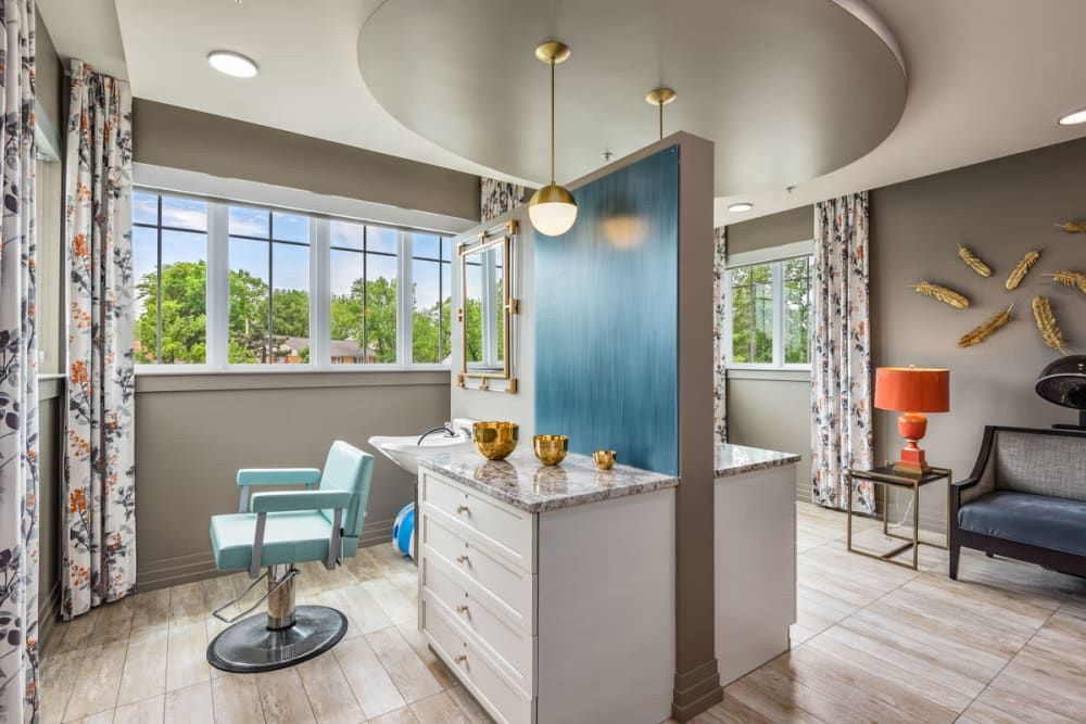 A modern hair salon interior with stylish decor and ample natural light.