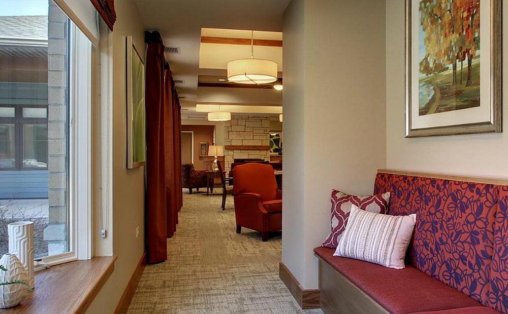 A cozy hallway with elegant seating and warm lighting.