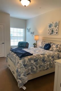 A cozy and elegantly decorated bedroom with a comfortable bed, stylish bedding, and warm lighting.