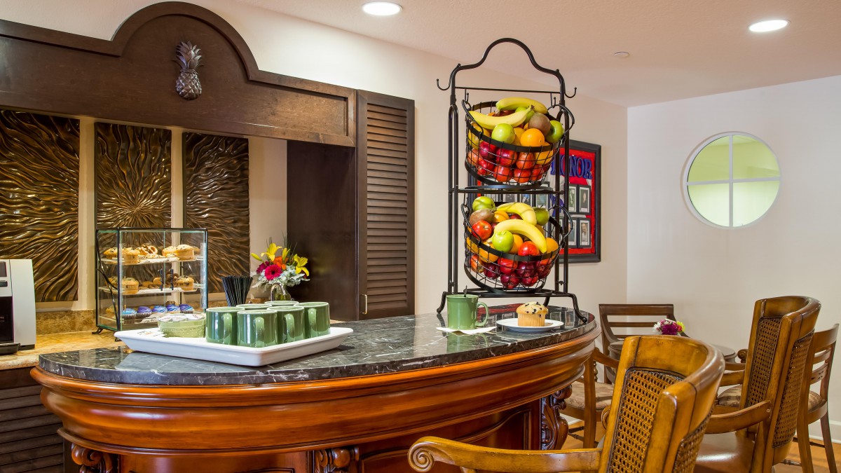 A cozy kitchen setting with a fruit basket on the countertop.