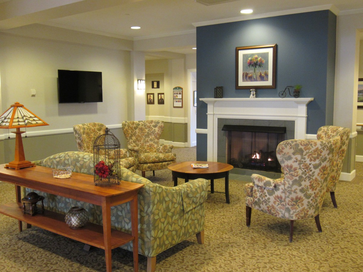 A cozy living room with a fireplace and comfortable seating.