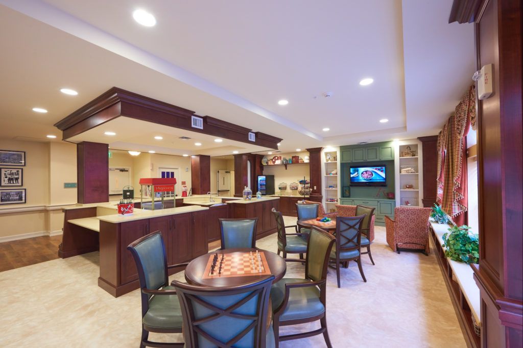 A modern lounge area with seating and a TV.
