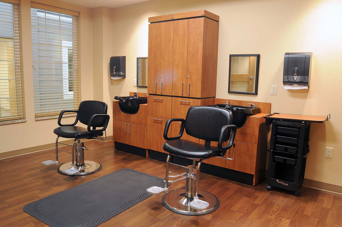 An interior view of a hair salon with styling chairs and mirrors.