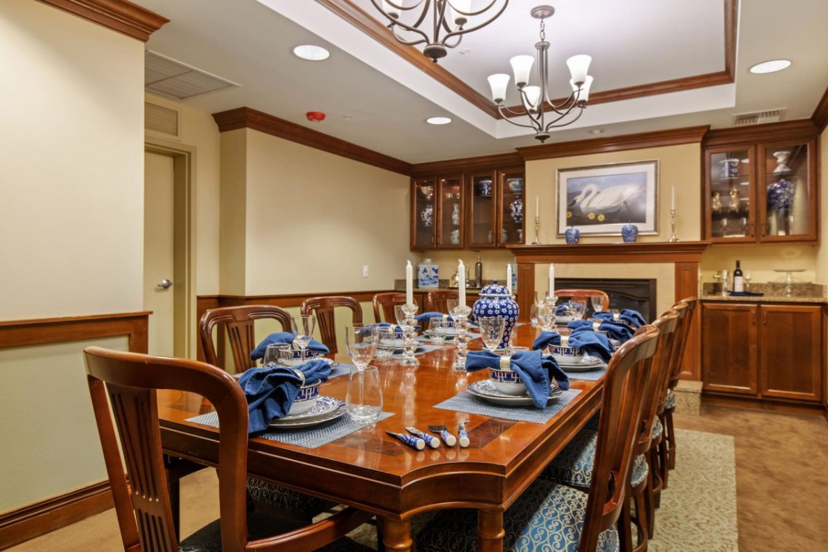 An elegant dining room with a formal table setting and classic decor.