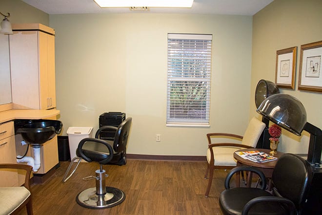 A cozy hair salon with styling chairs and a waiting area.