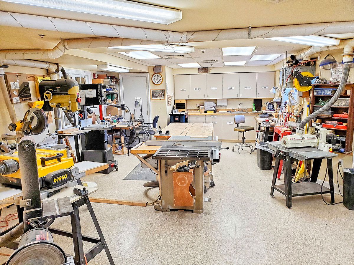 A well-organized woodworking workshop filled with various tools and machines.