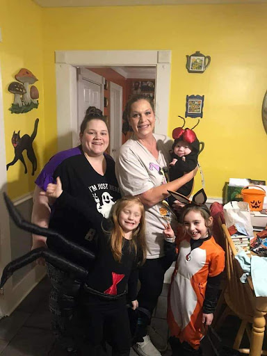 Family gathers for a fun Halloween celebration, showcasing their creative costumes!