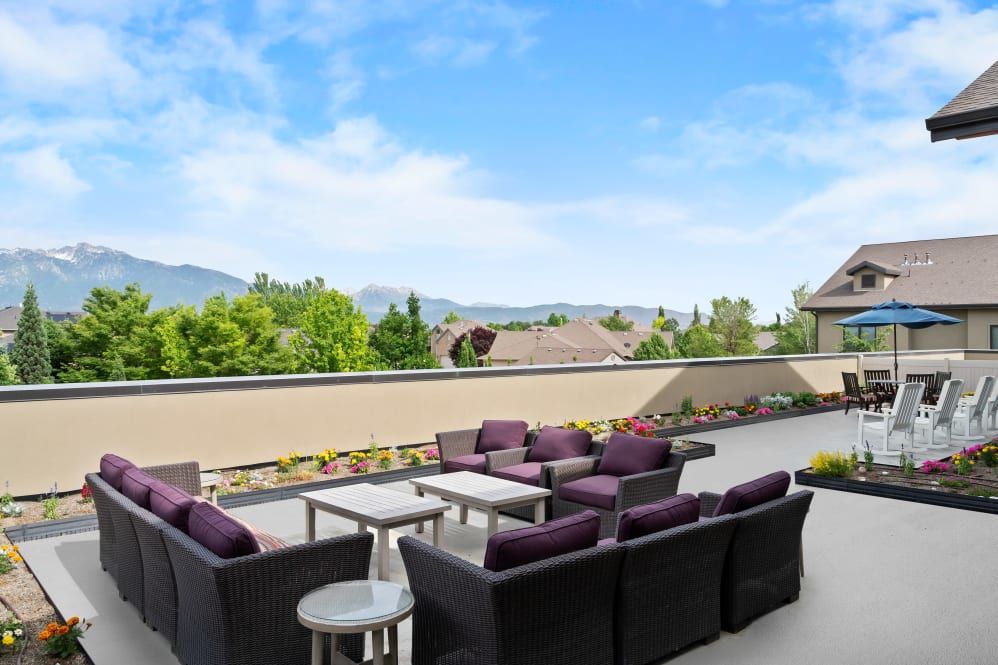 A spacious patio with comfortable seating and a scenic mountain view.