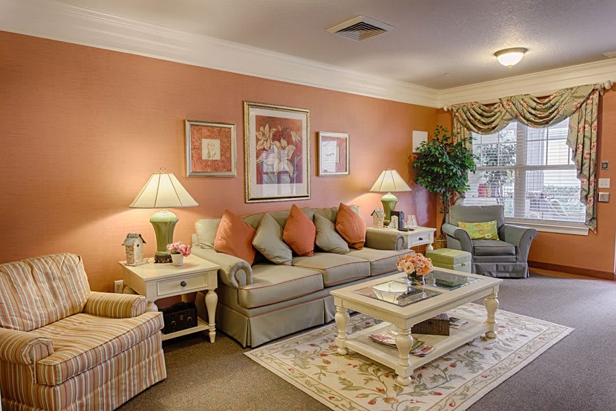 A cozy living room with a gray sofa, colorful pillows, and elegant decor.