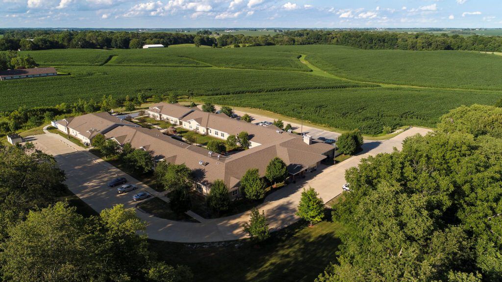 An aerial view of a building surrounded by lush green countryside and fields.