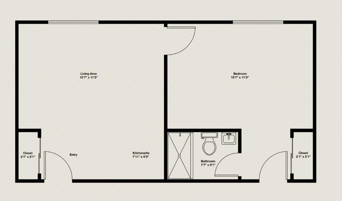 A simple floor plan depicting a living area, bedroom, and bathroom layout.