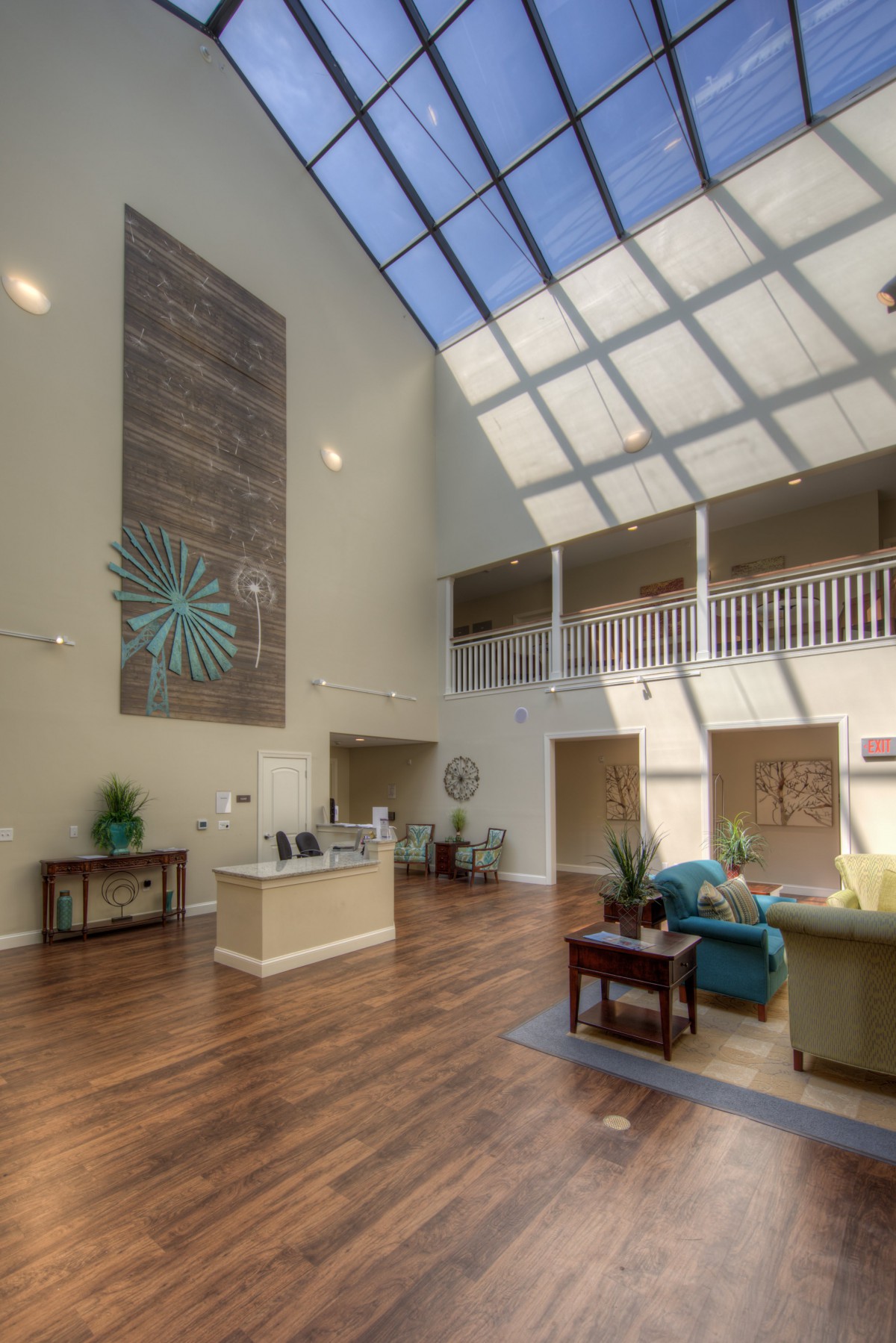 A spacious and bright lobby with modern furnishings and a large skylight.