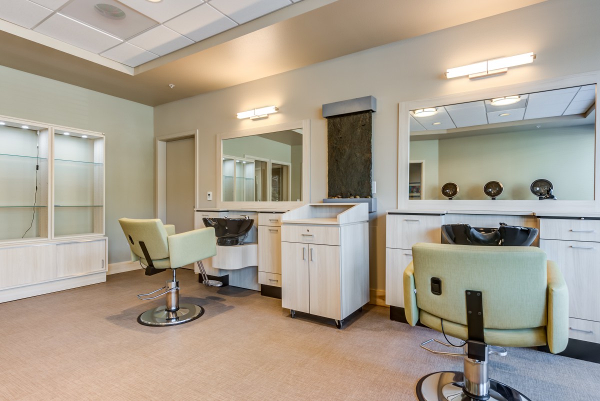 A well-lit hair salon interior with styling chairs and mirrors.