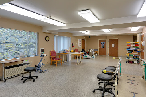 A spacious and well-lit therapy room designed for rehabilitation and physical therapy sessions.