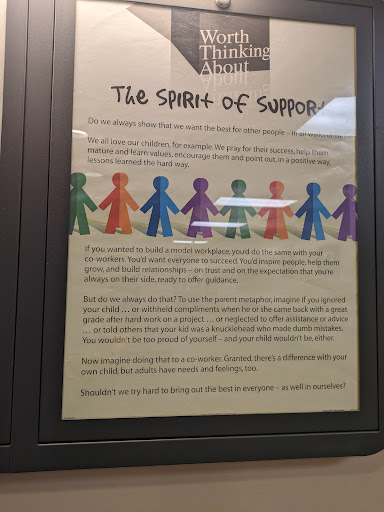 A poster illustrating the concept of community and support through colorful paper dolls holding hands.