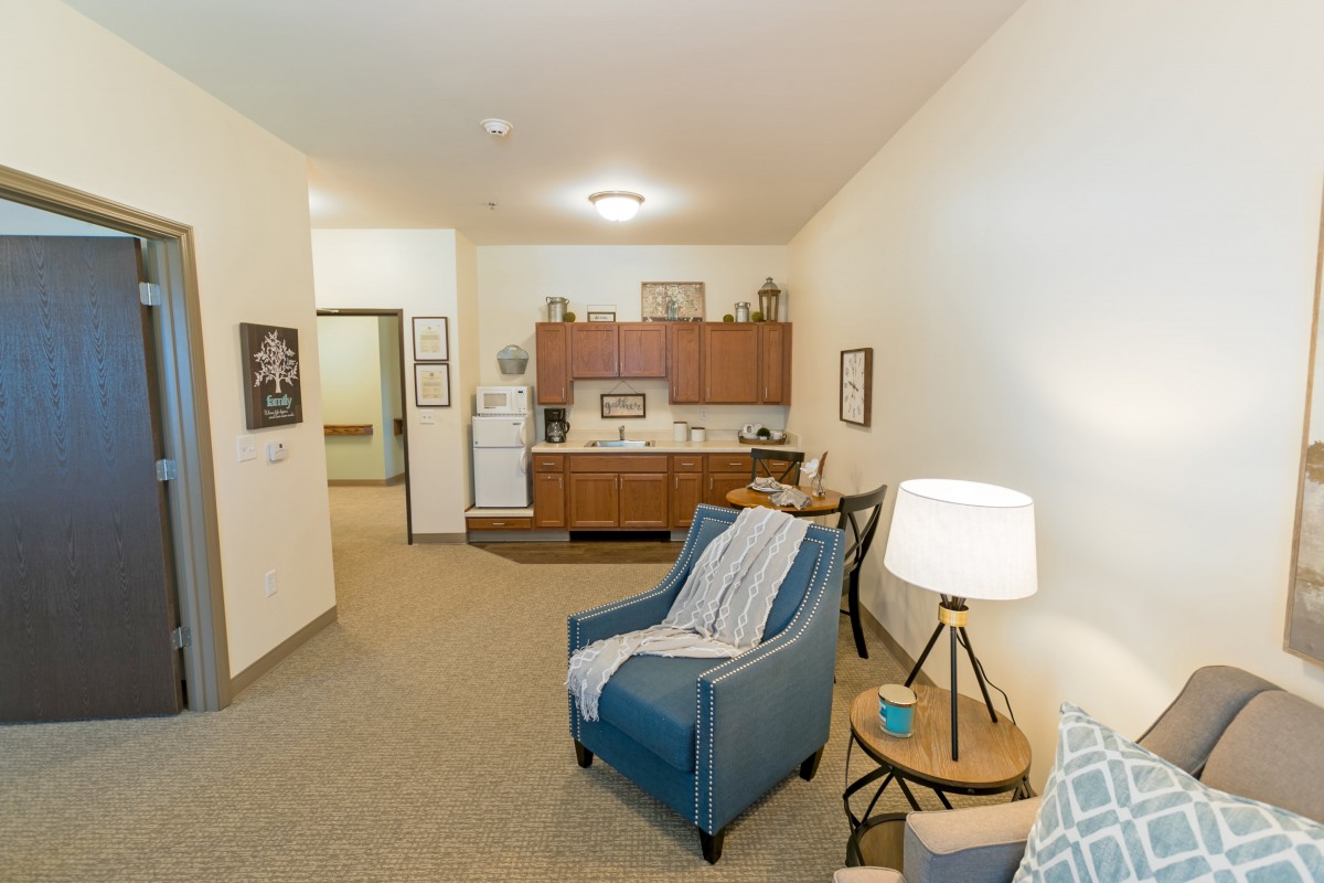 A cozy apartment interior with a living area and adjacent kitchen.