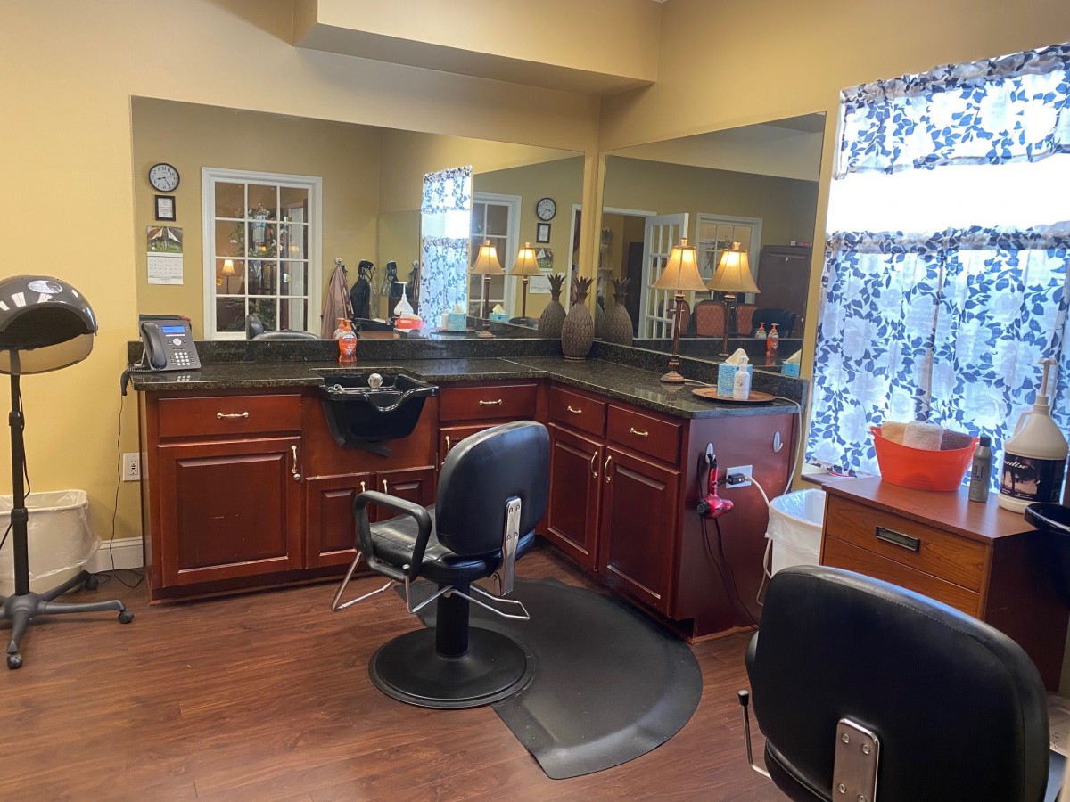 A cozy hair salon with stylish interior and multiple workstations.