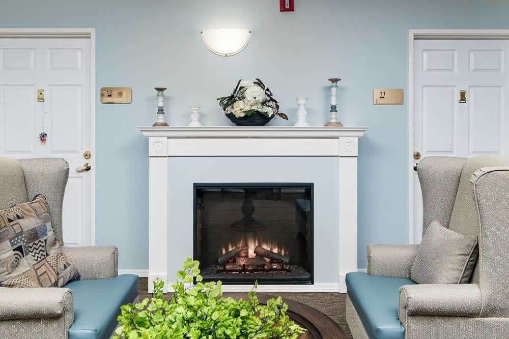 A cozy living room featuring a fireplace with modern decor and comfortable seating.