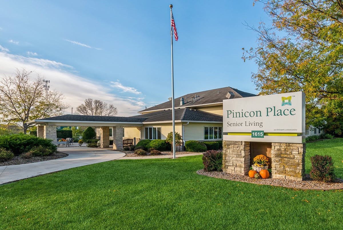 Entrance to a senior living facility with a welcoming driveway and manicured lawn.