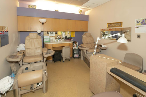 A well-equipped treatment room in a clinic, featuring comfortable chairs and organized workspaces.