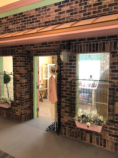 A charming storefront with a cozy entrance and decorative displays.