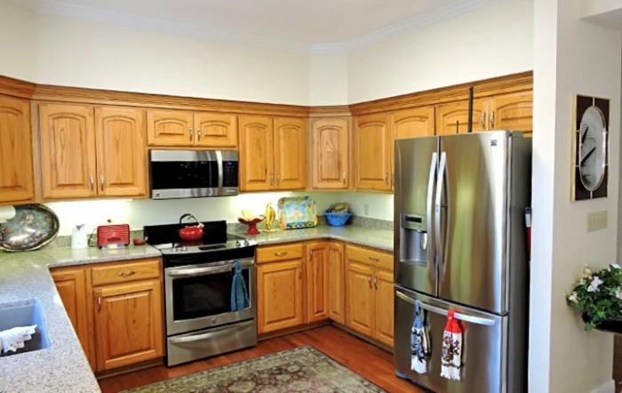 A traditional kitchen with wooden cabinets and stainless steel appliances.