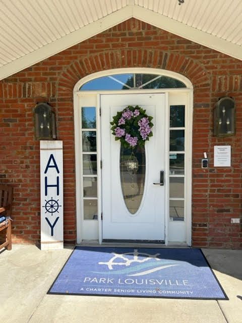 A welcoming entrance with a floral wreath and nautical-themed decor.