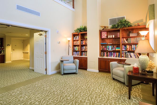A cozy library corner with comfortable armchairs and well-stocked bookshelves.