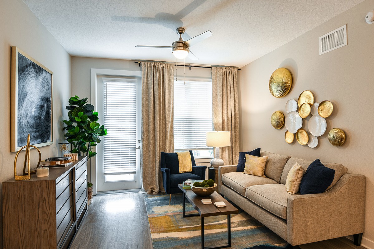 A well-decorated living room with a cozy sofa, modern armchair, and stylish wall decor.