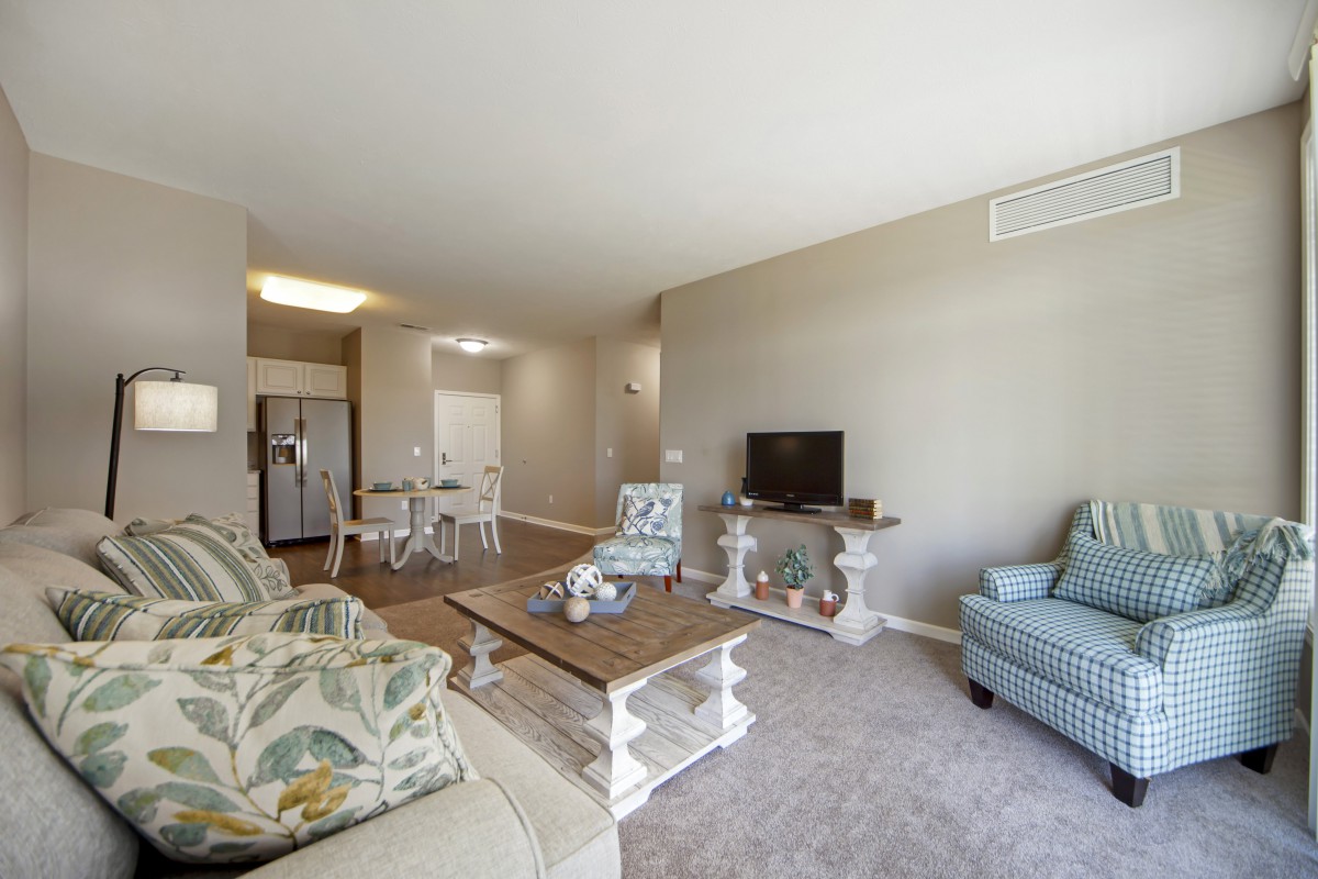 A modern living room with comfortable seating and a TV setup.