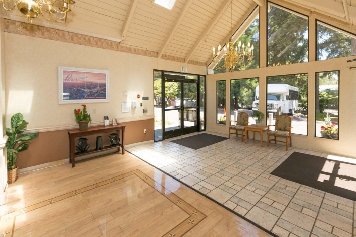 Bright and welcoming lobby with large windows and natural light.