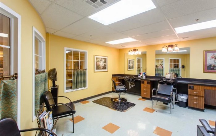 A well-lit hair salon with styling stations and chairs.