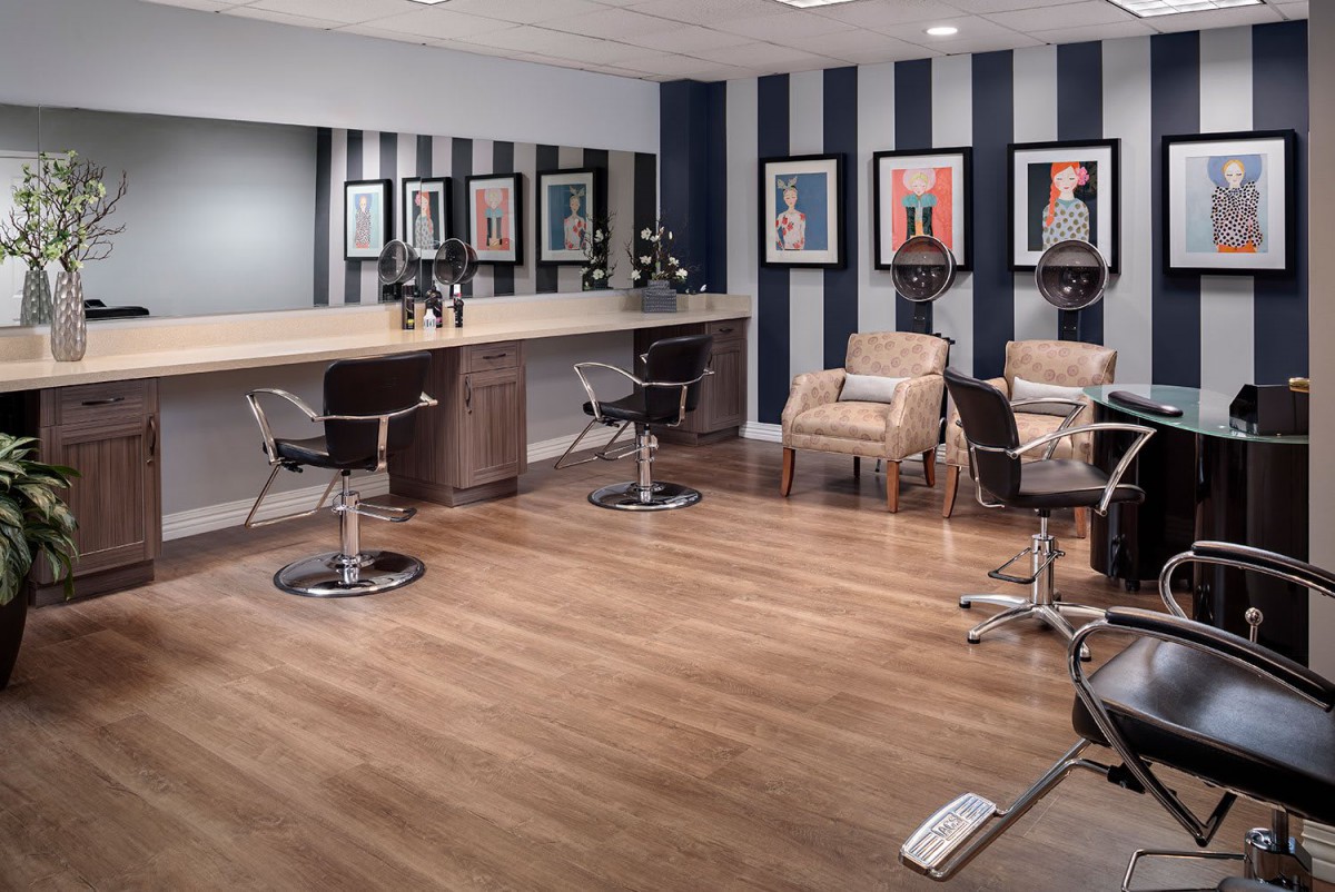 A modern hair salon with stylish decor and comfortable seating.
