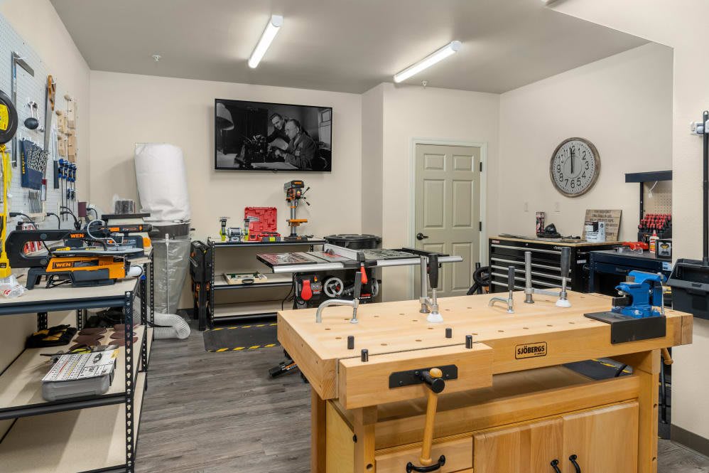 A well-organized workshop with tools and a workbench.